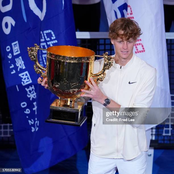 Winner Jannik Sinner of Italy poses with the trophy during the awards ceremony following his Men's Singles Final match against Daniil Medvedev on day...