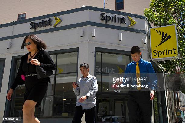 Pedestrians walk past a Sprint Nextel Corp. Store in San Francisco, California, U.S., on Thursday, June 13, 2013. SoftBank Corp. Chief Executive...