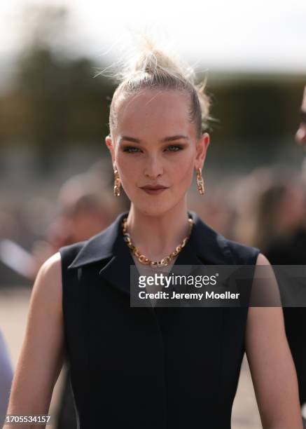 Guest is seen outside Dior show wearing golden chain earrings and matching necklace during the Womenswear Spring/Summer 2024 as part of Paris Fashion...
