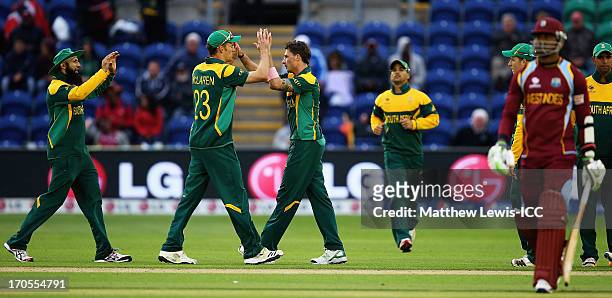 Dale Steyn of South Africa is congratulated by Ryan McLaren, after bowling Marlon Samuels of the West Indies during the ICC Champions Trophy Group B...