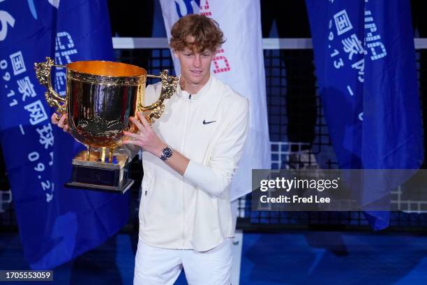 Winner Jannik Sinner of Italy poses with the trophy during the awards ceremony following his Men's Singles Final match against Daniil Medvedev on day...