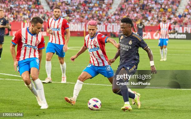 Yan Couto of Girona FC in action with Vinicius Jr of Real Madrid C.F. During La Liga EA Sports 2023/2024 match between Girona FC and Real Madrid F.C....