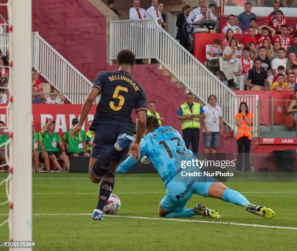 Paulo Gazzaniga of Girona FC in action with Jude Bellingham of Real Madrid C.F. During La Liga EA Sports 2023/2024 match between Girona FC and Real...