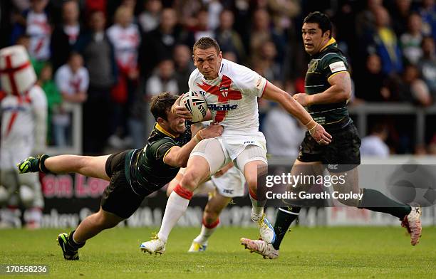 England captain Kevin Sinfield is tackled by Trent Waterhouse of the Exiles during the International Origin Match between England and Exiles at The...