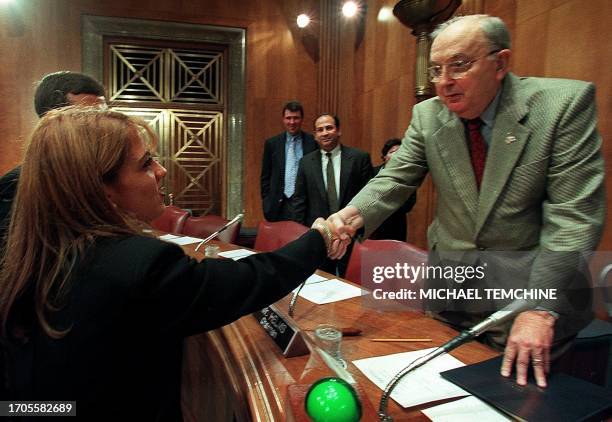 Dr. Noris Pena Martinez , a Cuban who defected to Zimbabwe during a medical mission, shakes hands with US Senator Jesse Helms , R-SC, 20 September,...