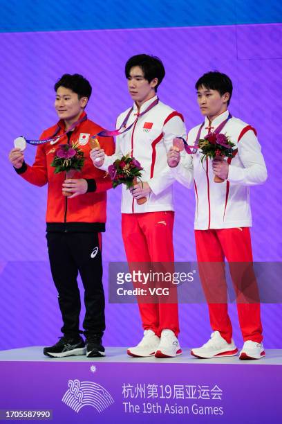 Silver medalist Takeru Kitazono of Team Japan, gold medalist Zhang Boheng of Team China and bronze medalist Lan Xingyu of Team China pose during the...