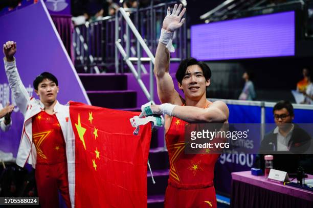 Zhang Boheng of Team China celebrates after winning the Artistic Gymnastics - Men's All-Around Final on day three of the 19th Asian Games at...
