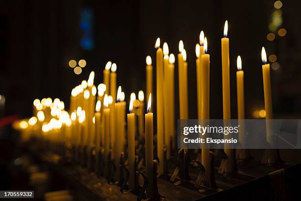 lit candles in church interior at christmas - religion background stock pictures, royalty-free photos & images