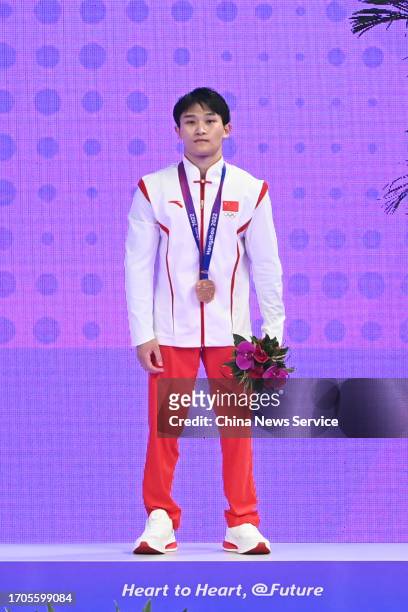 Bronze medalist Lan Xingyu of Team China poses during the medal ceremony for the Artistic Gymnastics - Men's All-Around Final on day three of the...