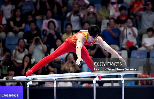 Zhang Boheng of Team China competes on the Parallel Bars in the Artistic Gymnastics - Men's All-Around Final on day three of the 19th Asian Games at...