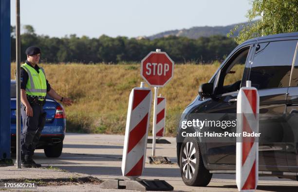 Austrian police check cars and vans arriving from Slovakia at the Austrian-Slovak border on October 4, 2023 in Berg, Austria. Austria began border...