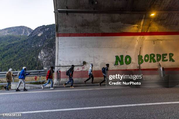 Italy Migrants walk dangerously along the state road to France when buses end the service.?On March 10th a significant number of migrants, mainly...