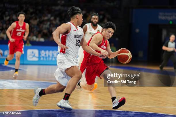 Terashima Ryo of Japan in action against Noor Muhamad Arighi Hadran of Indonesia during the Baskeball Preliminary Round match between Team Japan and...