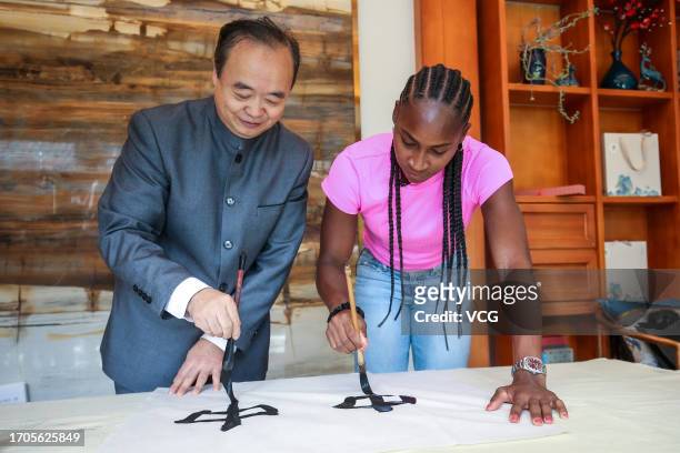 Coco Gauff of the United States learns to write Chinese calligraphy on day three of 2023 China Open on September 28, 2023 in Beijing, China.