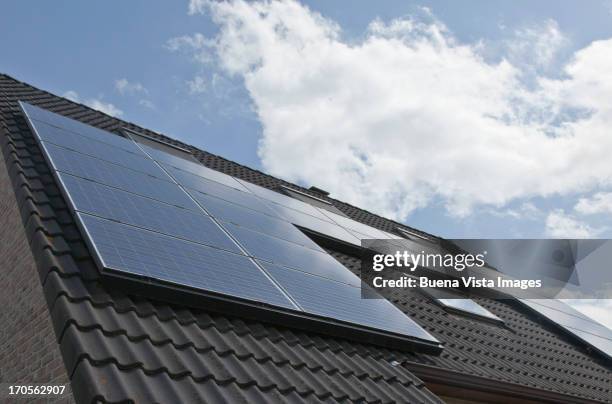 house with solar panels on the roof - solar panel stock pictures, royalty-free photos & images