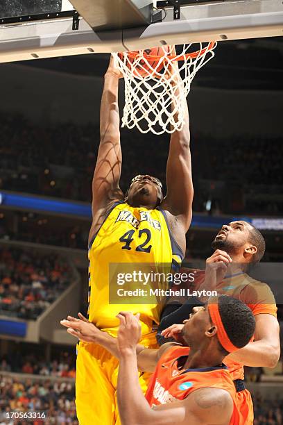 Chris Otule of the Marquette Golden Eagles makes a jam during the East Regional Round Final of the 2013 NCAA Men's Basketball Tournament game against...