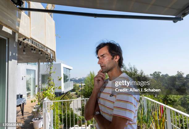 Los Angeles, CA Aleksandar Jovanovic, a Airbnb landlord, stands on the deck of his Los Angeles home. His tenant, Elizabeth Hirschhorn, not pictured,...