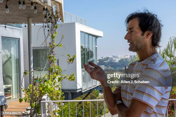 Los Angeles, CA Aleksandar Jovanovic, a Airbnb landlord, stands on the deck of his Los Angeles home. His tenant, Elizabeth Hirschhorn, not pictured,...