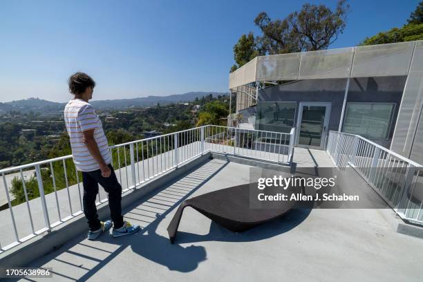 Los Angeles, CA Aleksandar Jovanovic, a Airbnb landlord, looks out over a patio space on top his guesthouse, located on the property of his Los...