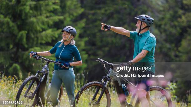 senior couple at autumn bike tour in mountains. - fahrrad fahren alte leute beine stock-fotos und bilder