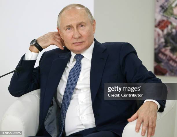 Russian President Vladimir Putin gestures during his meeting with children in the Sirius Education Center on October 4 in Sirius Federal Territory,...