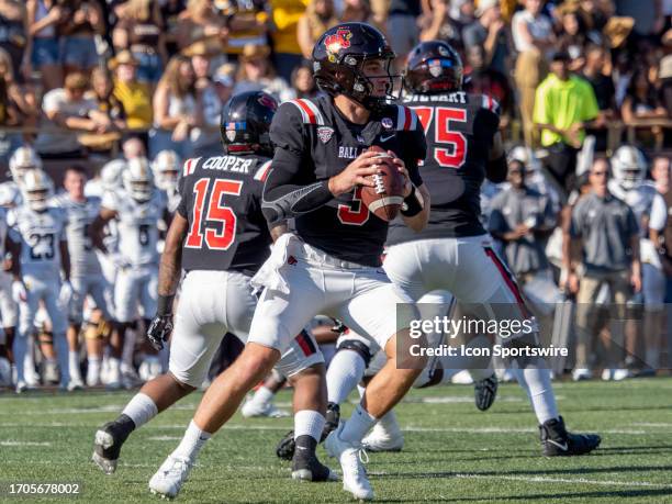 Ball State Cardinals quarterback Layne Hatcher looks to pass the ball to his teammate during the college football game between the Ball State...