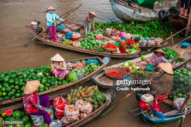 vietnamese women selling fruits on floating market, mekong river delta, vietnam - river mekong stock pictures, royalty-free photos & images