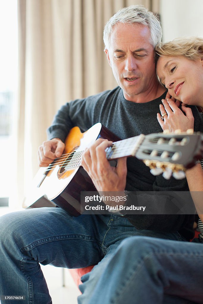 Man playing guitar for wife