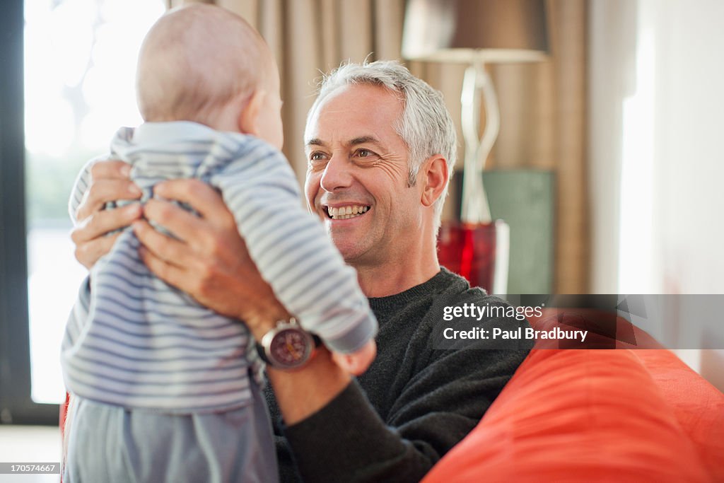 Man holding baby boy on lap