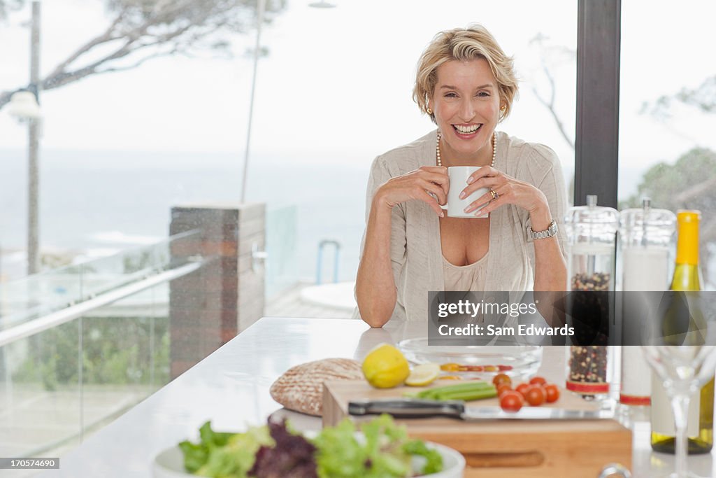 Woman drinking coffee in kitchen