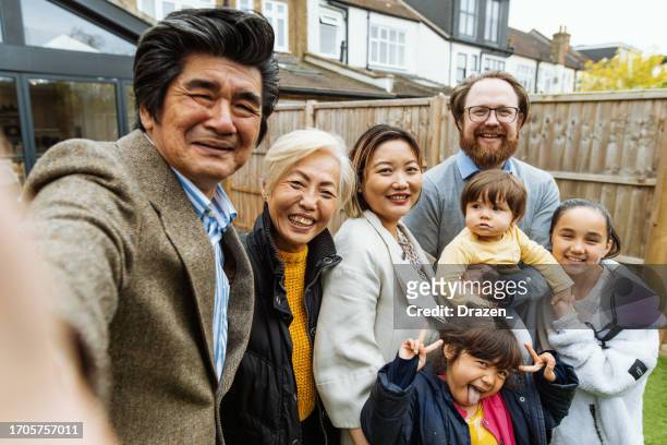 family portrait of multi generation family, outdoors in front of the house - northern european descent stock pictures, royalty-free photos & images