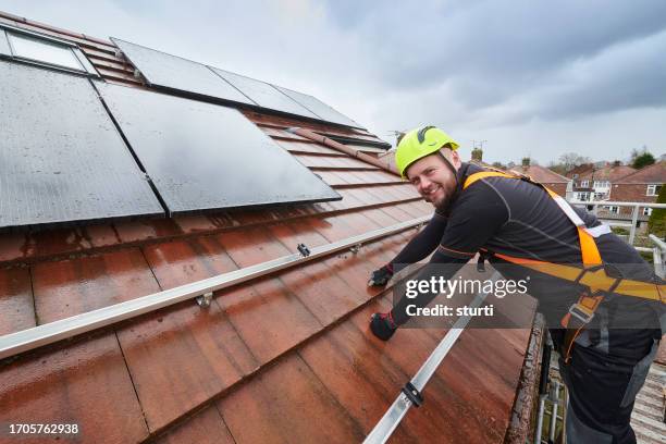 fitting the rooftop solar panels - safety harness stock pictures, royalty-free photos & images