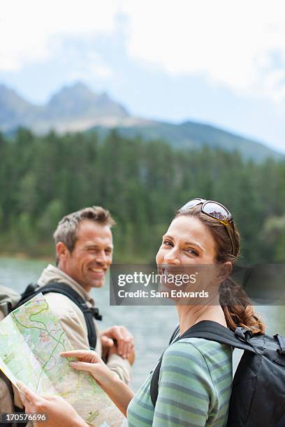 couple hiking and looking at map in remote area - woman map stock pictures, royalty-free photos & images