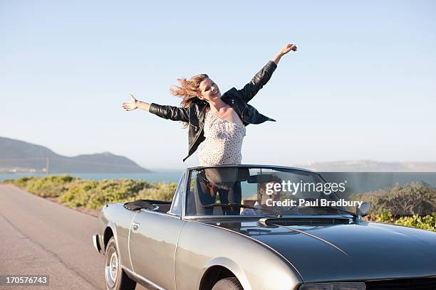 couple riding in car  together - convertible car stock pictures, royalty-free photos & images