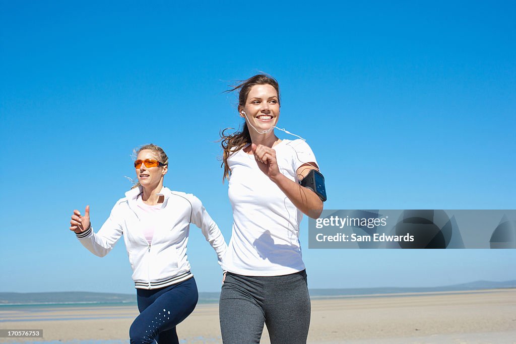 Friends running on beach