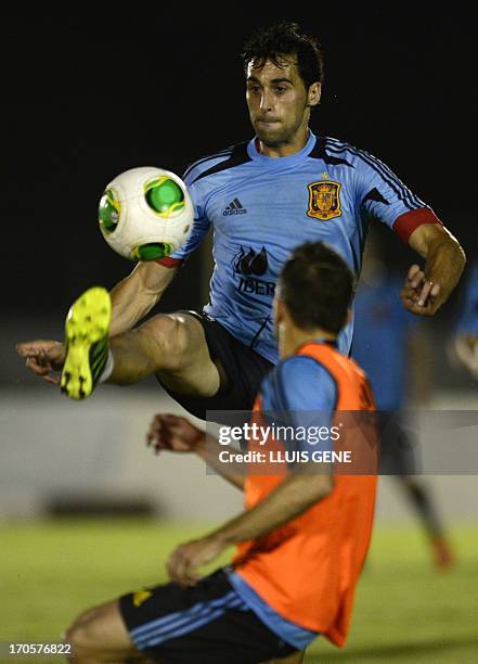 Spain's defenders Raul Albiol and Jordi Alba vie during a training session at the Wilson Campos Training Center near Recife, northeastern Brazil, on...