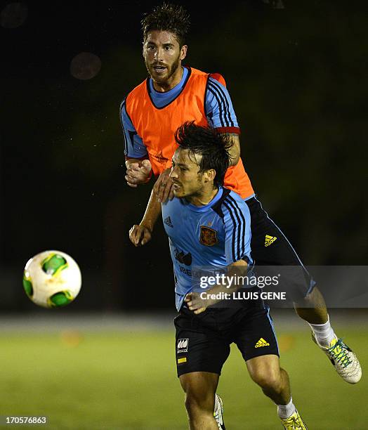 Spain's defender Sergio Ramos and forward David Silva vie during a training session at the Wilson Campos Training Centre near Recife, northeastern...