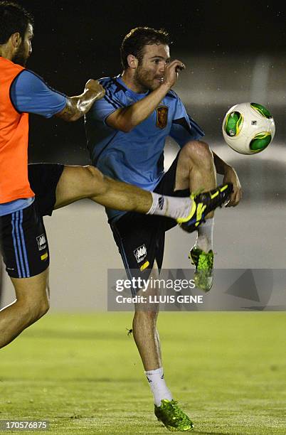 Spain's midfielder Cesc Fabregas vies with forward Juan Mata during a training session at the Wilson Campos Training Centre near Recife, northeastern...