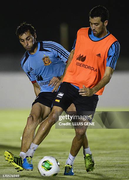 Spain's defender Raul Albiol and midfielder Sergio Busquets take part in a during a training session at the Wilson Campos Training Centre near...