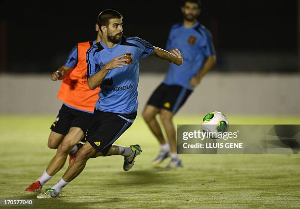 Spanish defender Gerard Pique follows the ball during a training session at the Wilson Campos Training Center near Recife, northeastern Brazil, on...