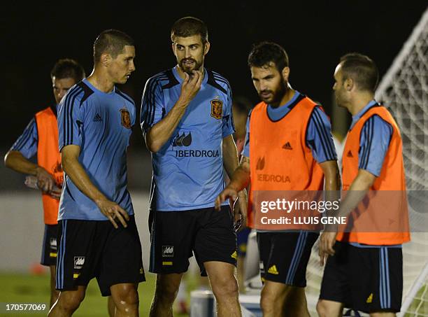 Spanish forward Fernando Torres, defender Gerard Pique, midfielder Cesc Fabregas and midfielder Andres Iniesta take part in a training session at the...