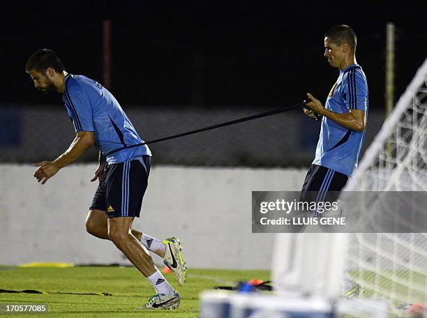 Spanish defender Gerard Pique and forward Fernando Torres take part in a training session at the Wilson Campos Training Center near Recife,...