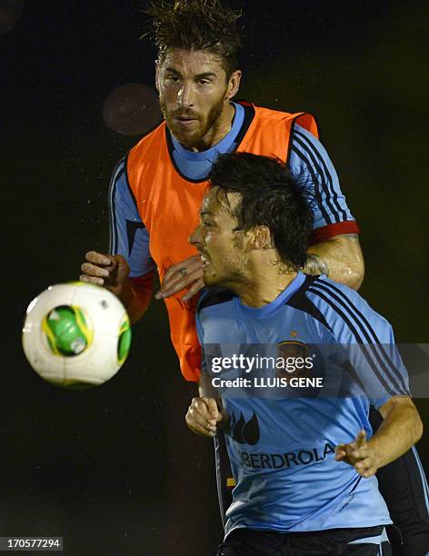 Spain's defender Sergio Ramos vies with forward David Silva during a training session at the Wilson Campos Training Center near Recife, northeastern...