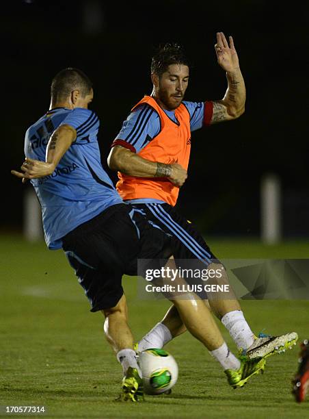 Spanish forward Fernando Torres vies with defender Sergio Ramos during a training session at the Wilson Campos Training Center near Recife,...