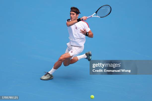 Tomas Martin Etcheverry of Argentina returns a shot in the Men's Singles Round of 32 match against Lloyd Harris of South Africa on day 3 of the 2023...