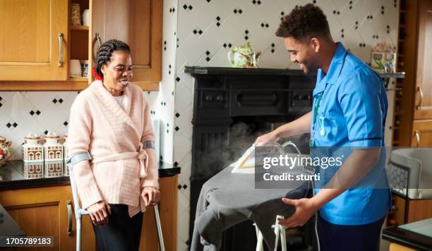 home care visit - iron appliance stock pictures, royalty-free photos & images