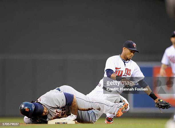 Prince Fielder of the Detroit Tigers slides intro second base safely with a double as Pedro Florimon of the Minnesota Twins fields the ball during...