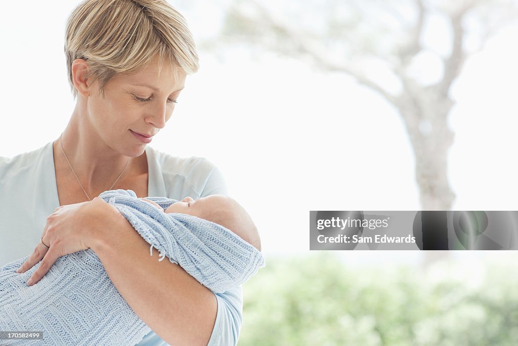 Woman holding newborn baby