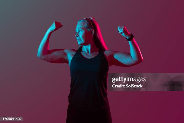 tensing muscles and feeling good - flexing muscles stock pictures, royalty-free photos & images