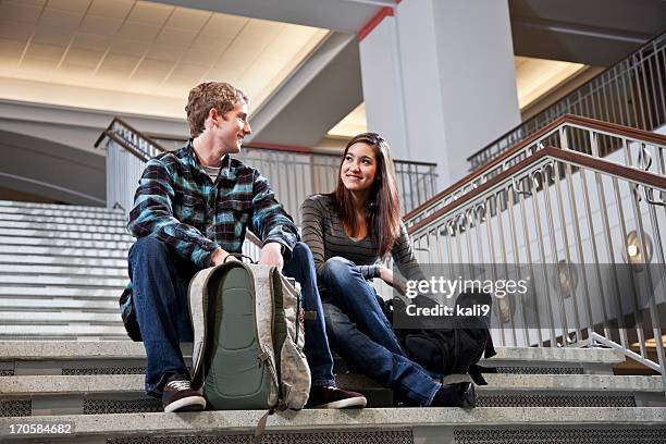 multiracial students on steps of school building - boy and girl talking stock pictures, royalty-free photos & images